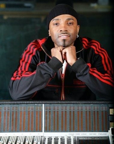 teddy riley posing behid a Mix Console